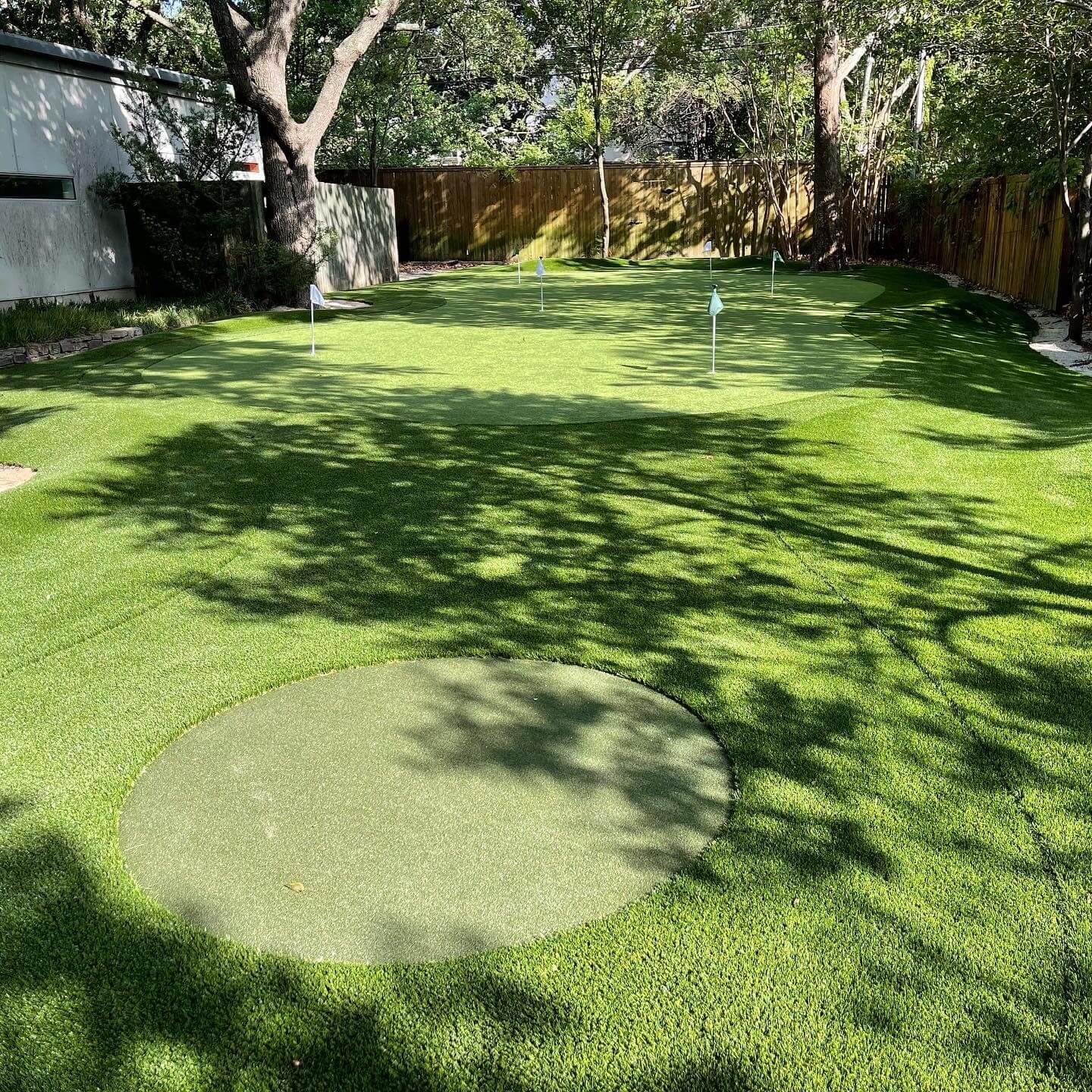 Alternate angle of shaded backyard putting green