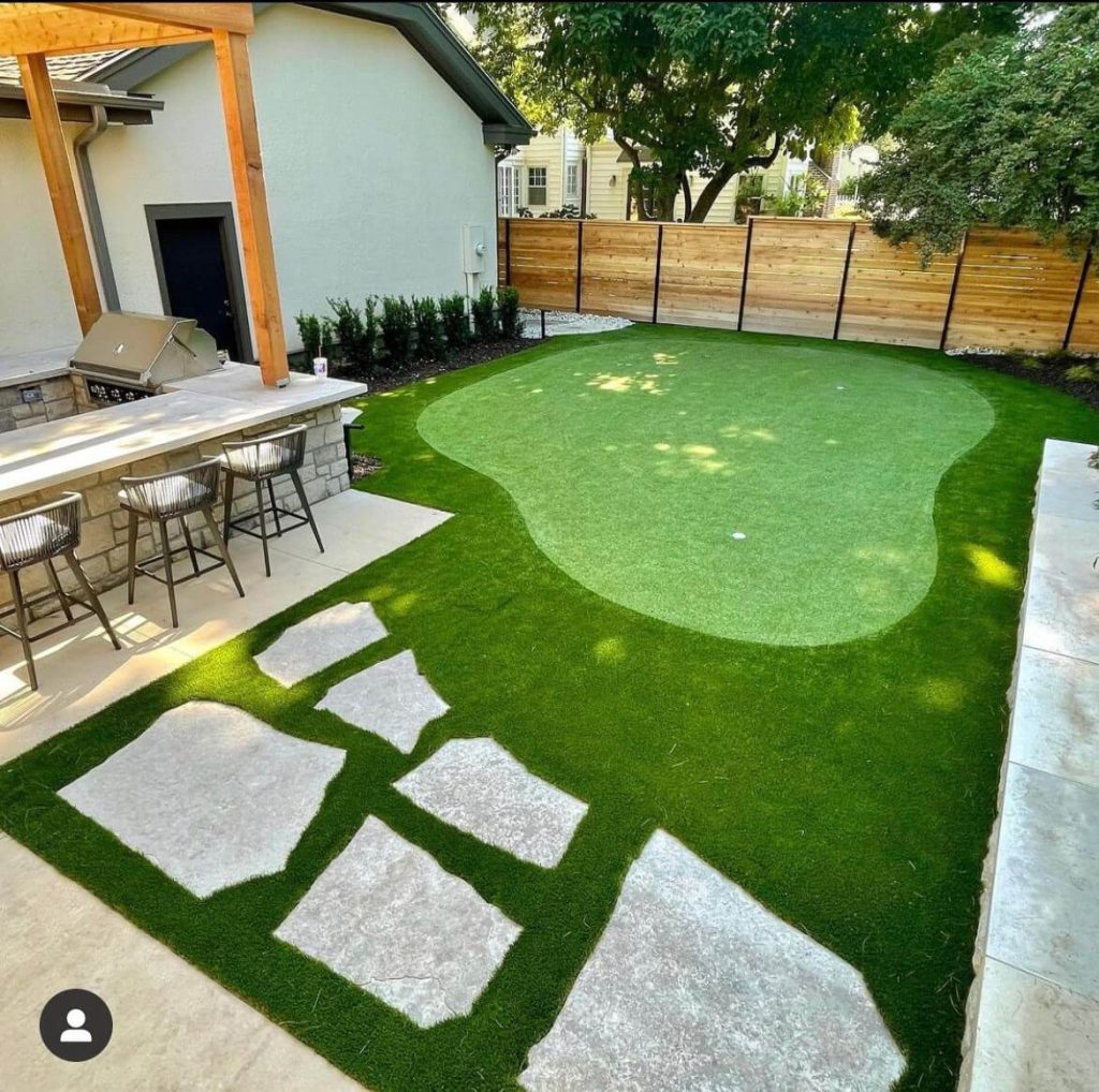 residential putting green next to grill 