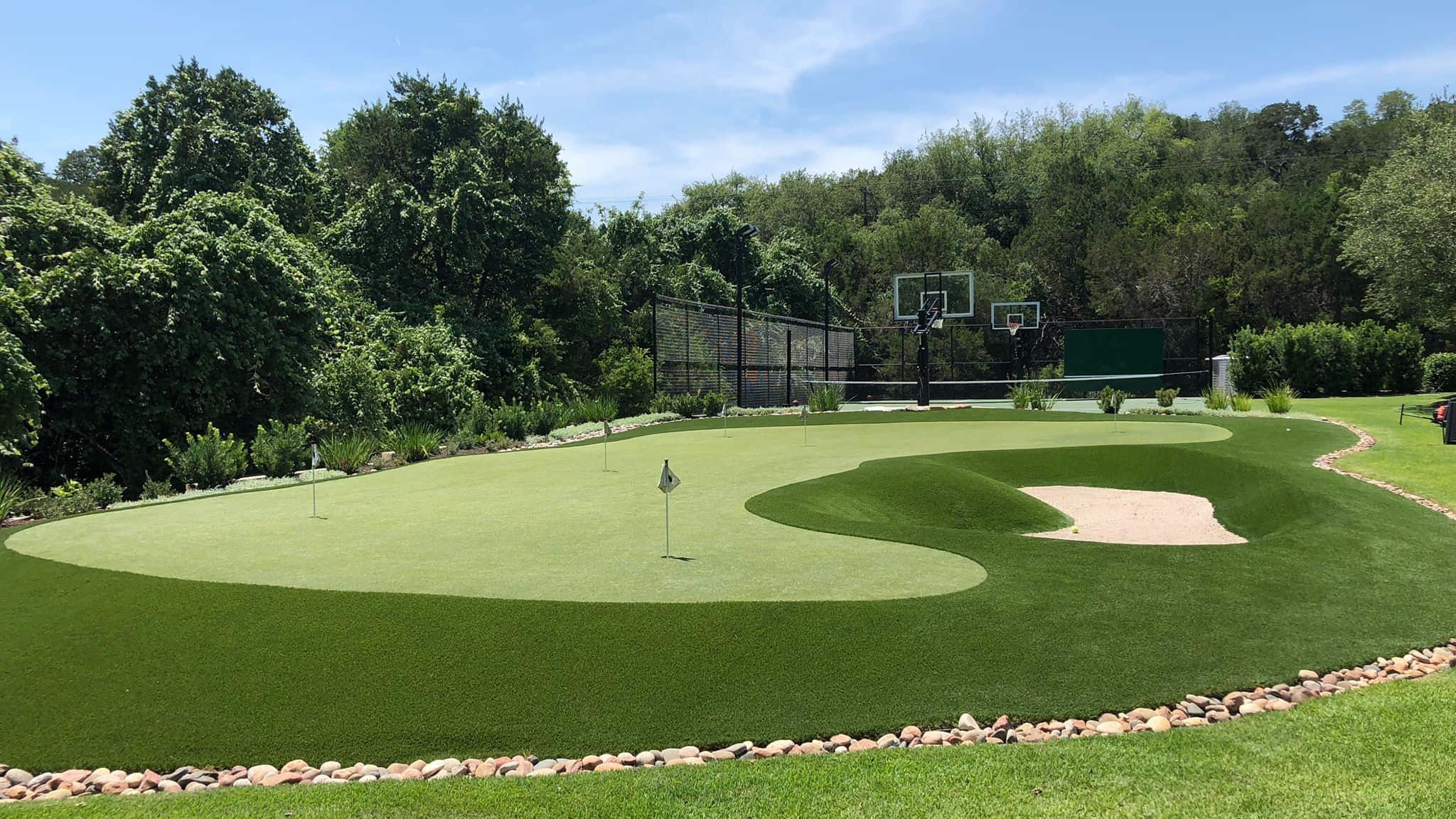 Putting green next to basketball court on artificial grass