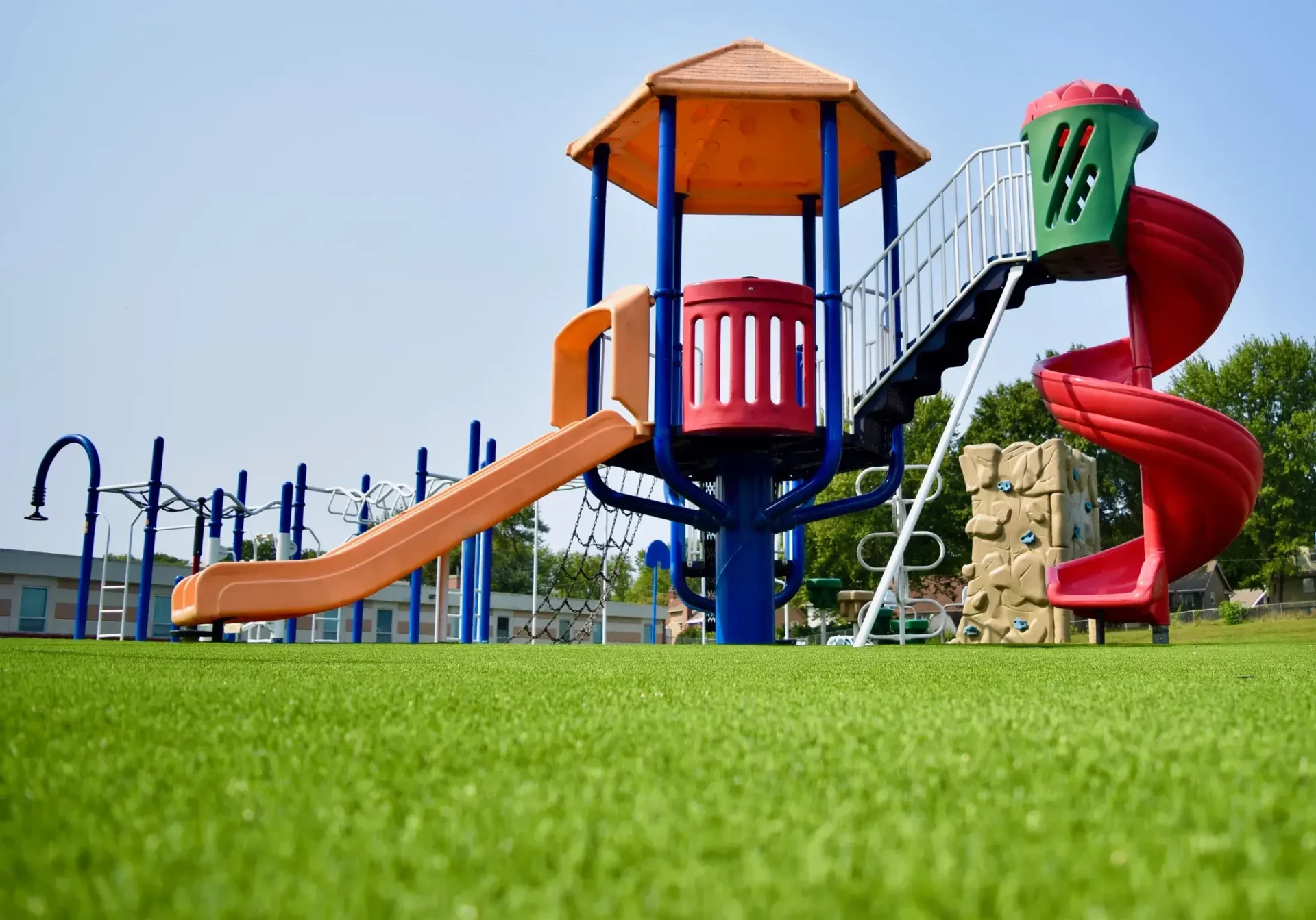 Ground view of artificial playground grass with jungle gym