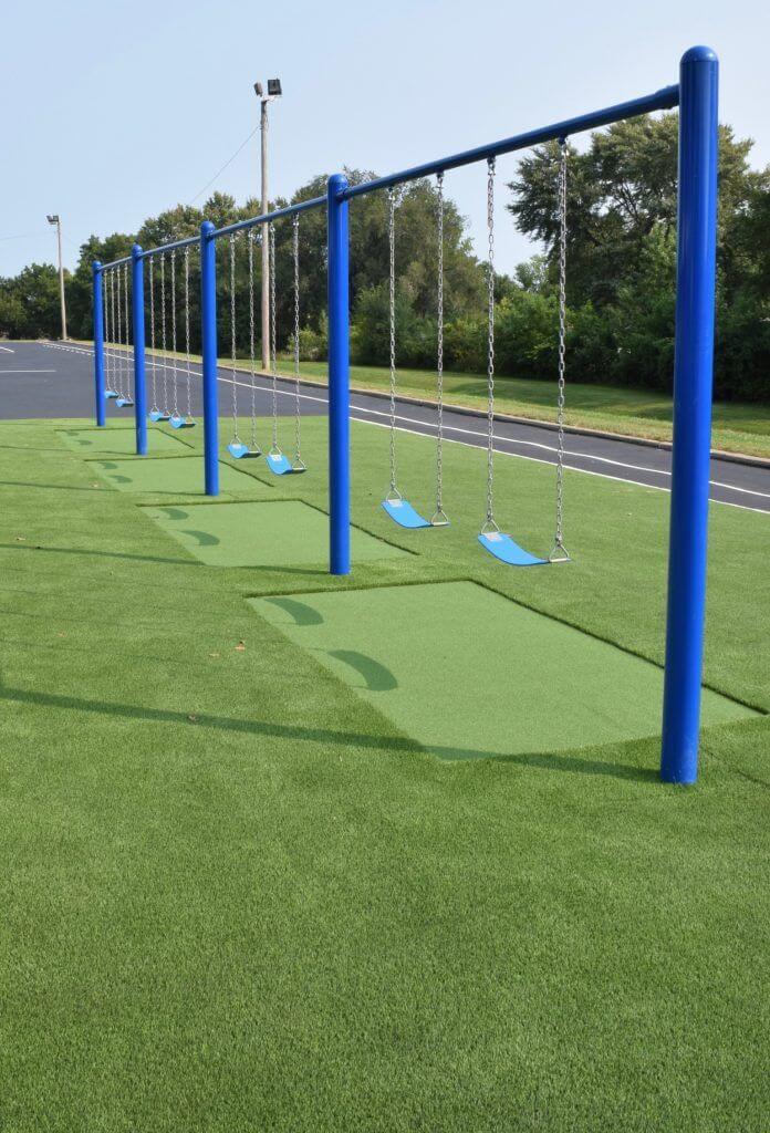 Artificial grass with swing set installed 