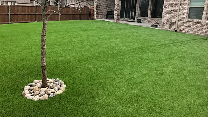 Artificial grass front yard with tree