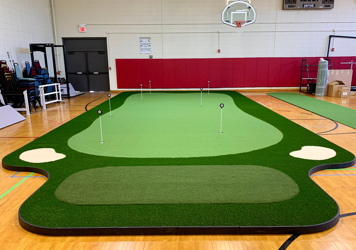Indoor artificial grass putting green in gym