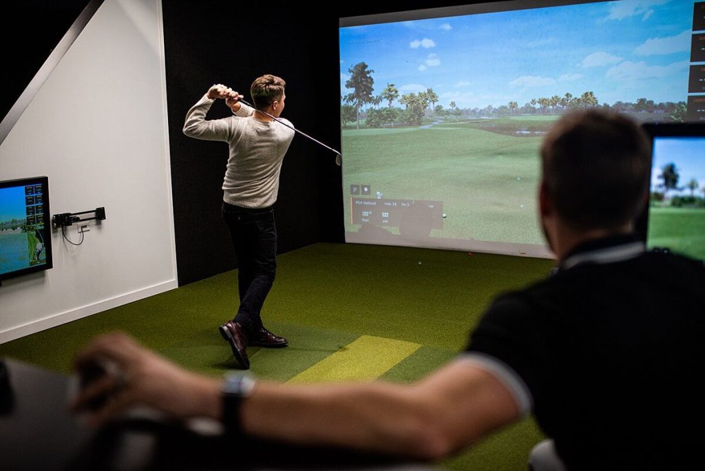 Golfer practicing virtual golf