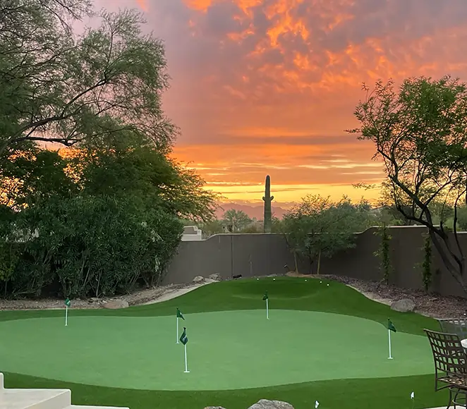 Residential golf green with sunset